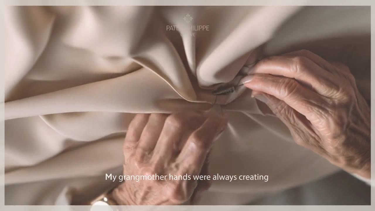 A grandmother’s hands folding fabric, the watch on her wrist.