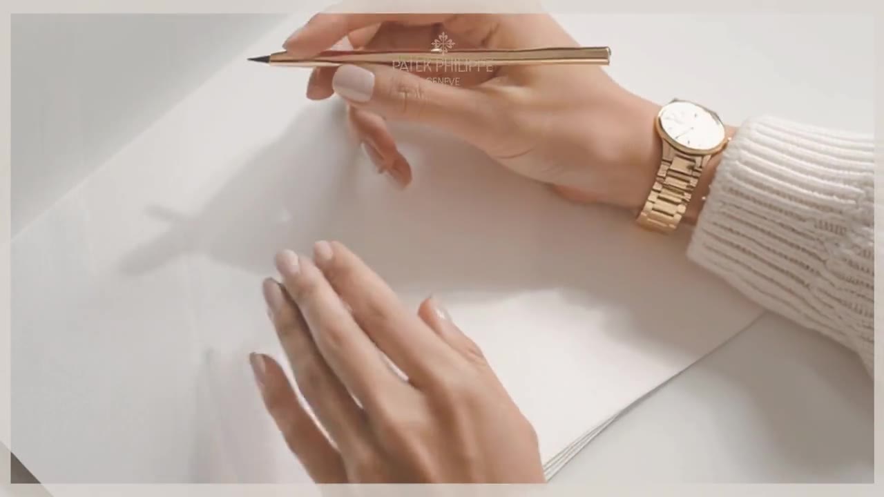 A younger hand with the same watch, writing.