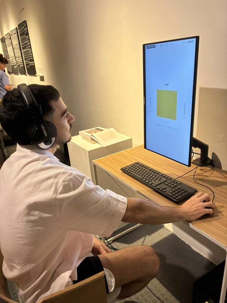 A visitor with headphones working on a single word.